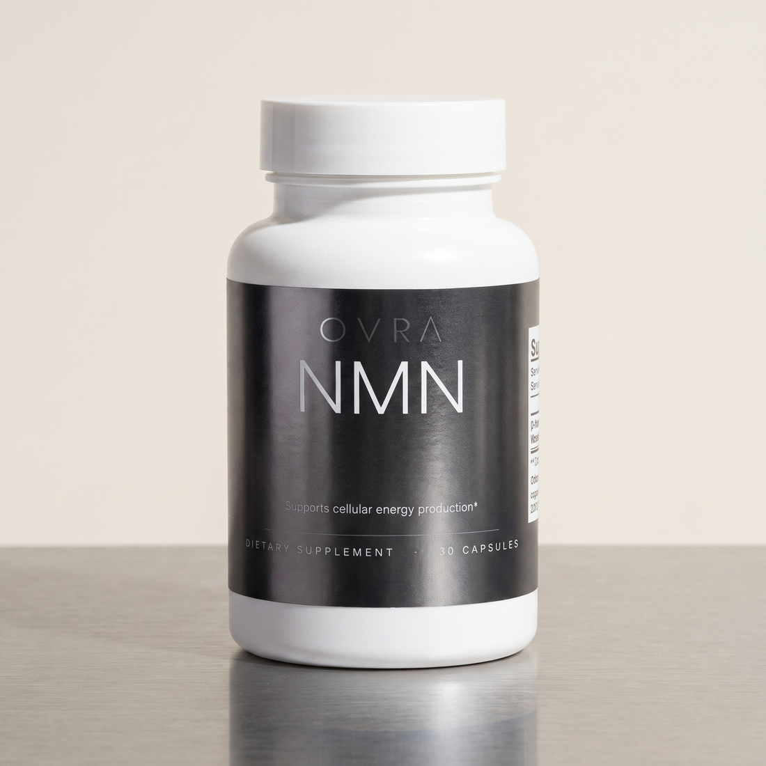 OVRA NMN bottle on brushed steel