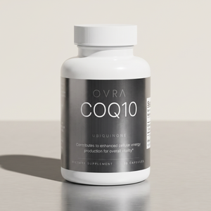 OVRA CoQ10 bottle on brushed steel, bone-white studio background