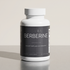 OVRA Berberine bottle on brushed steel, bone-white studio background